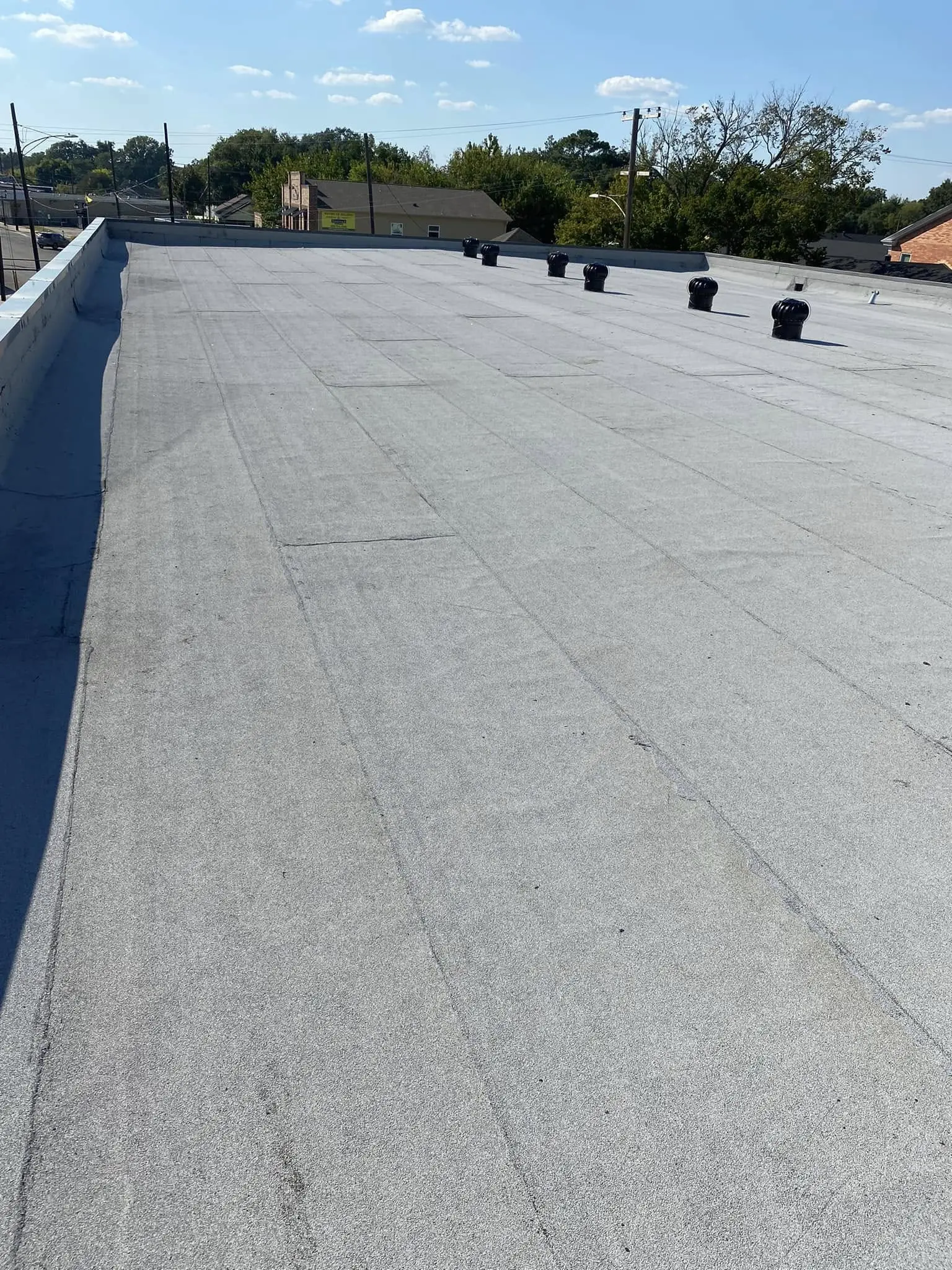 Flat commercial roof system in Groves TX with HVAC units