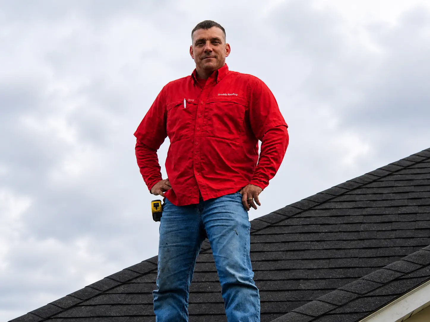 Seth Droddy owner of Droddy Roofing standing on residential roof in Groves TX